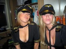 Two pretty chicks in captain's caps and wing tags